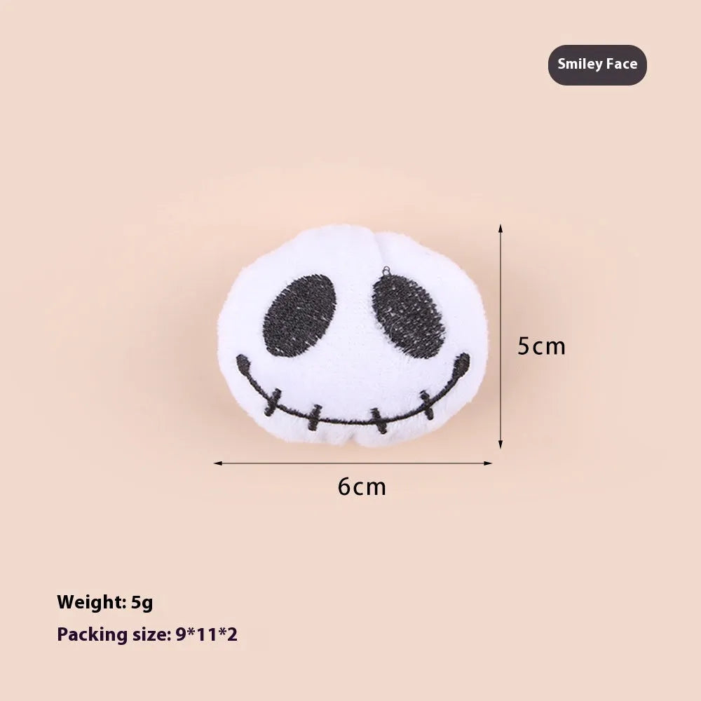 Plush cat wand toy with 27cm handle showing three interchangeable colourful heads: eyes, candy, and skull designs