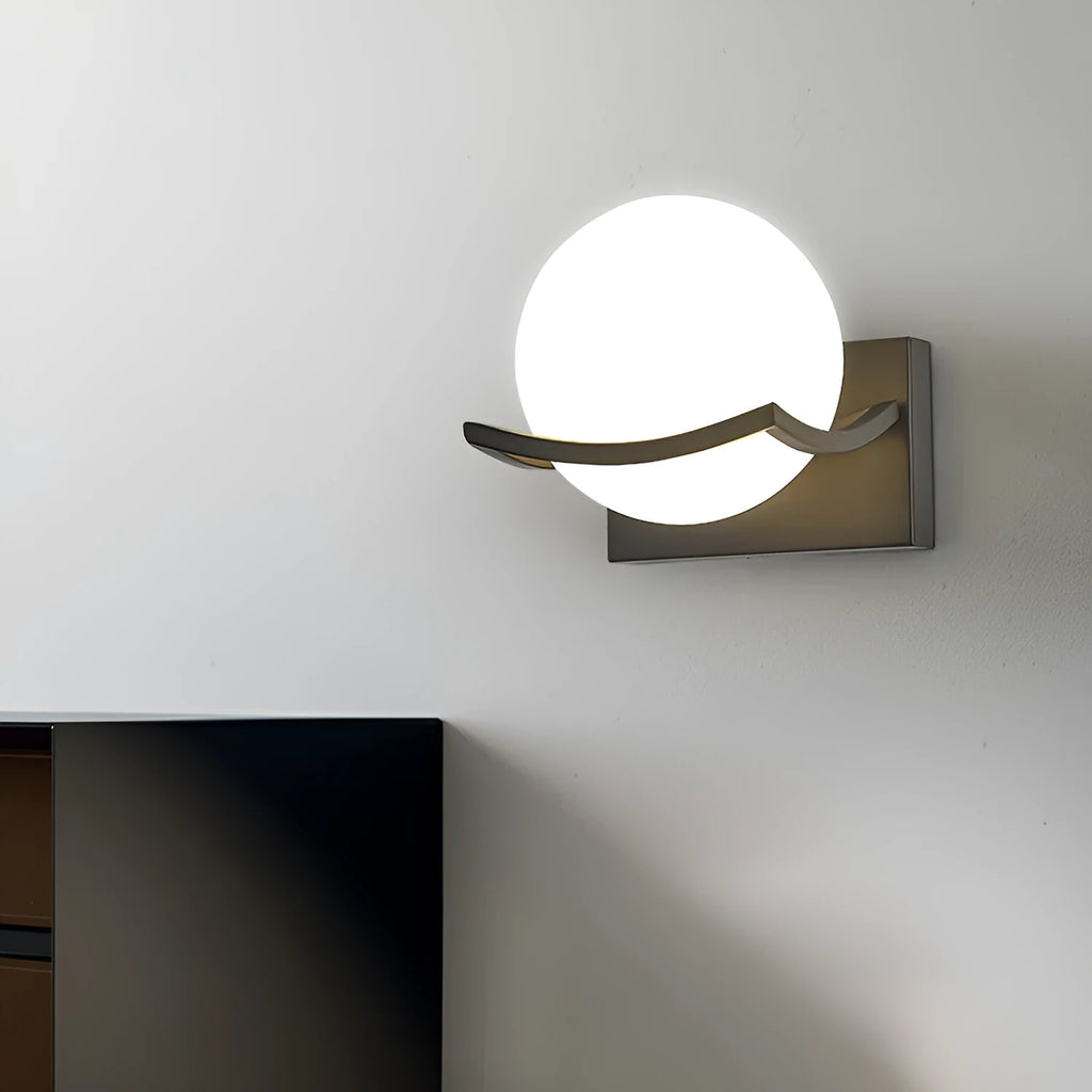 Modern minimalist black wall lamp with striped clear cover mounted beside a bed