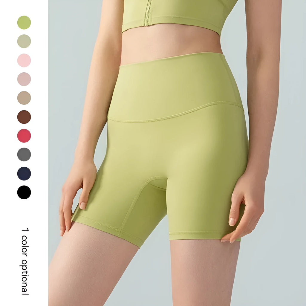 Women's high-waisted Lycra yoga shorts in leaf green, showing anti-exposure construction and short length.
