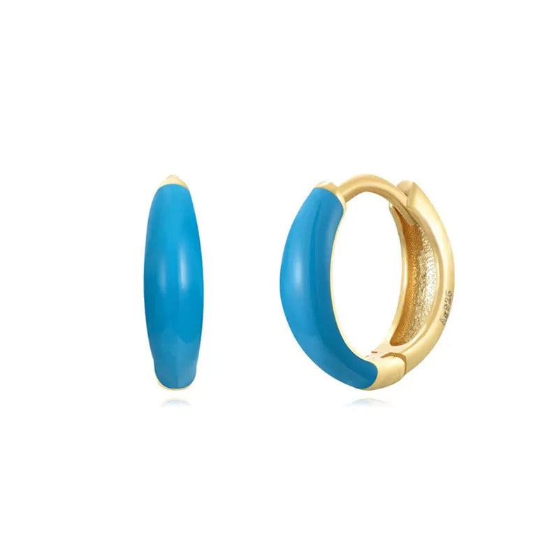 Geometric epoxy resin earrings with dripping oil colour technique showing oval curves and integrated rings