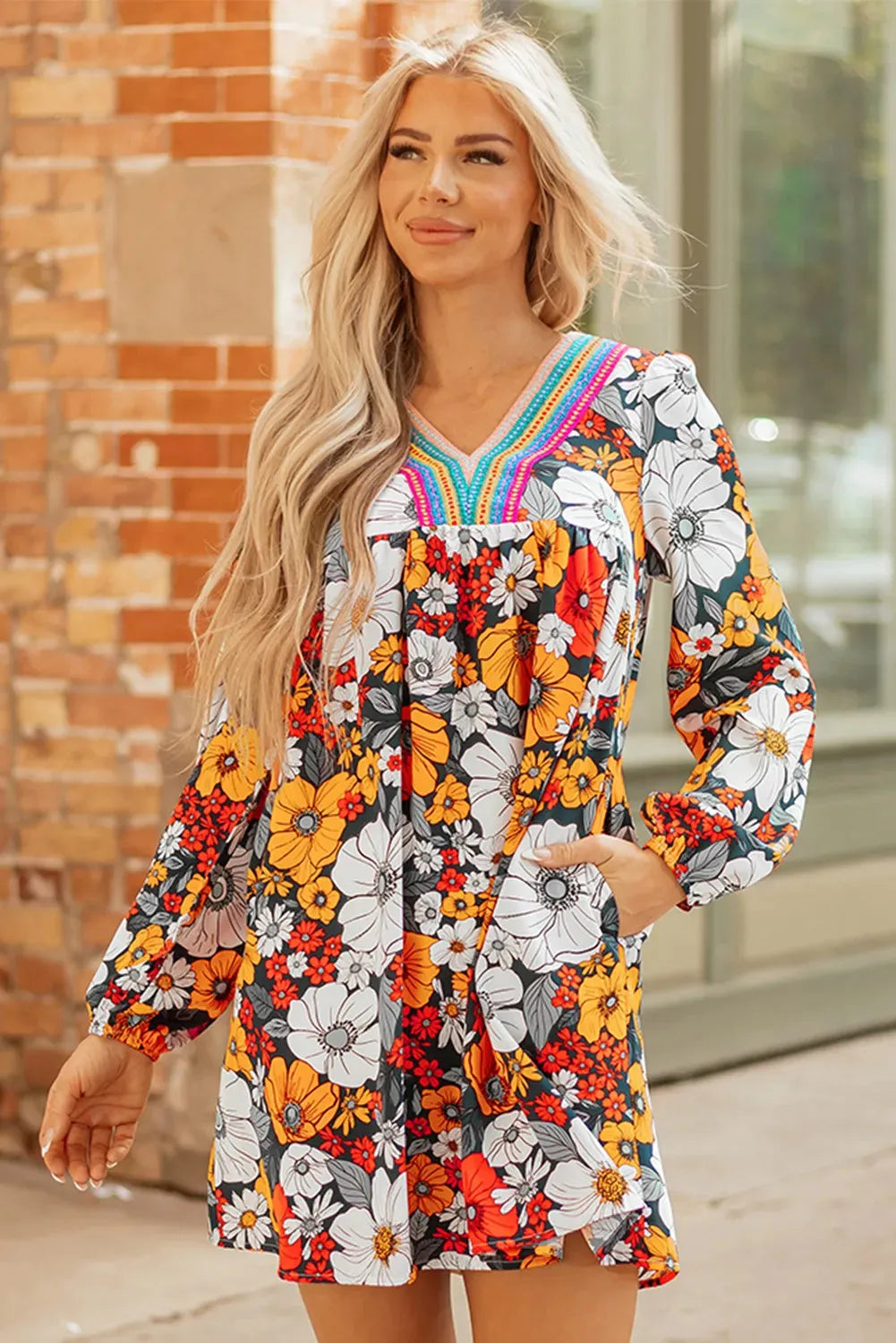 Orange floral print mini dress with lace-trimmed V-neck and long sleeves.