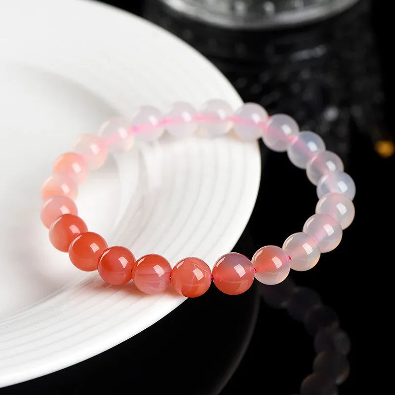 Natural gradient Yanyuan Agate bracelet showing graduated colour on geometrically shaped beads in a single circle.
