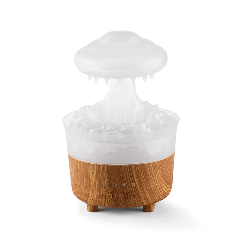 Wood grain white rain cloud shaped humidifier and essential oil diffuser with LED lights on a table.