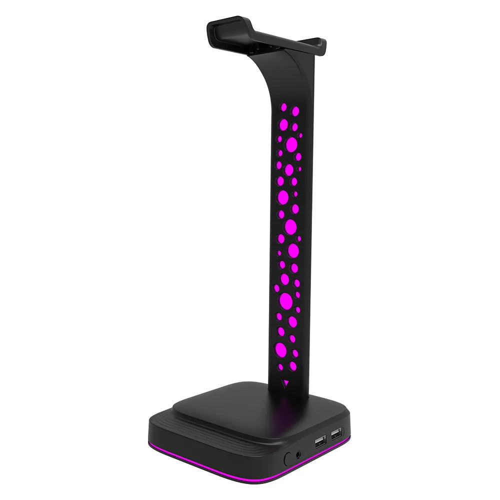 RGB colour-changing headphone display bracket with integrated dual USB ports on a desk.