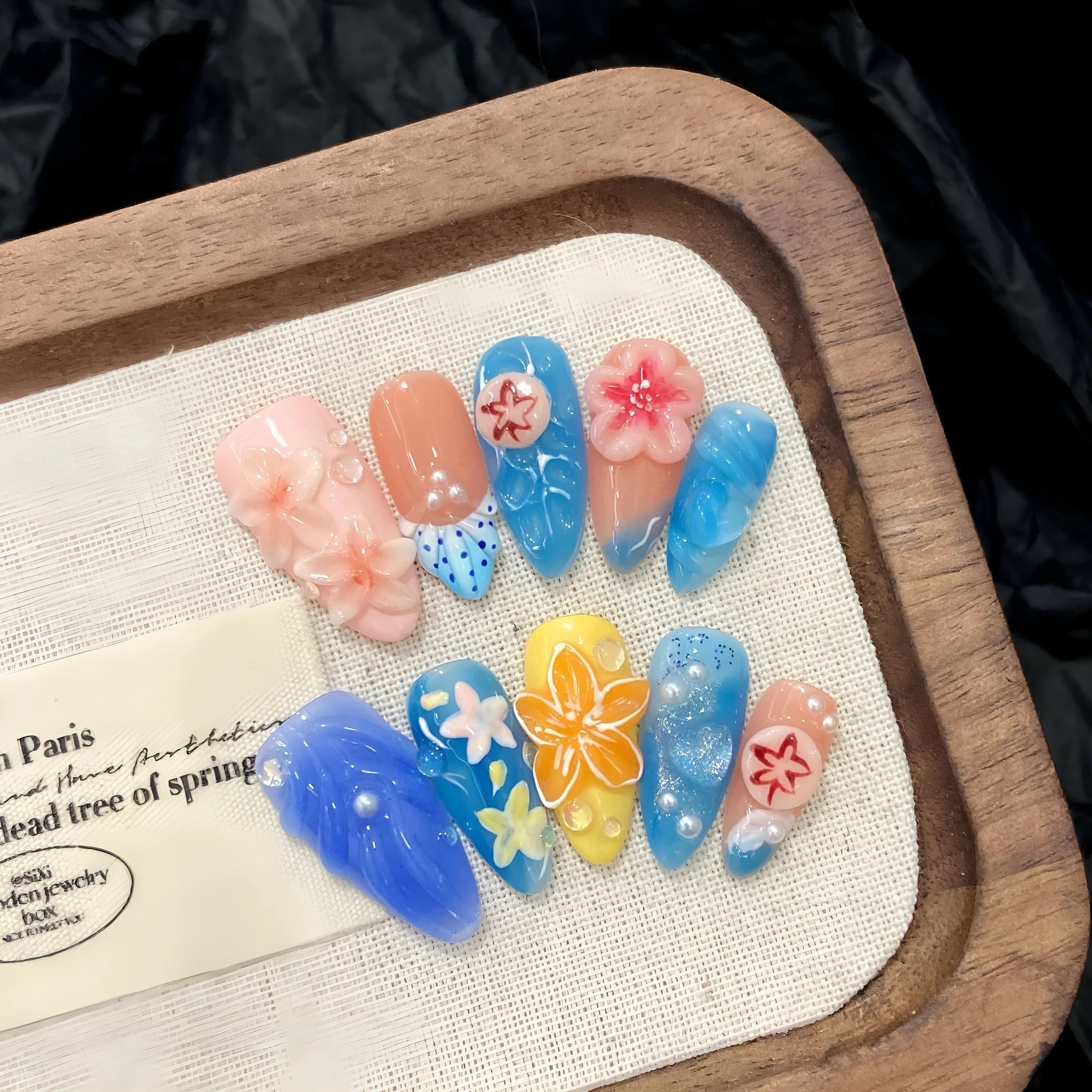 Plastic wearable armour with three-dimensional carved jellyfish marine design in almond nail colour
