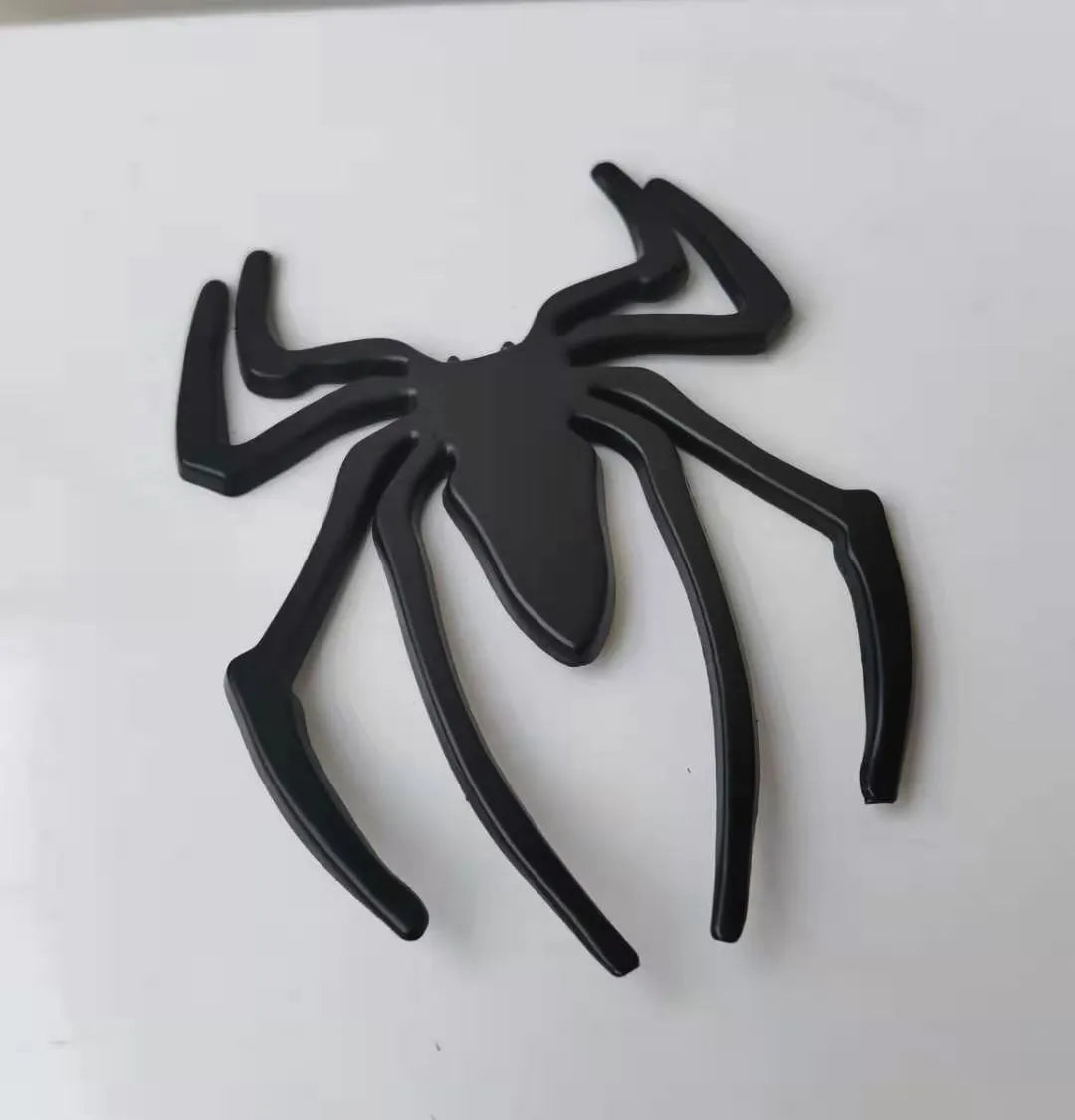 Three-dimensional metal spider sticker in gold colour, measuring 7cm by 5cm.