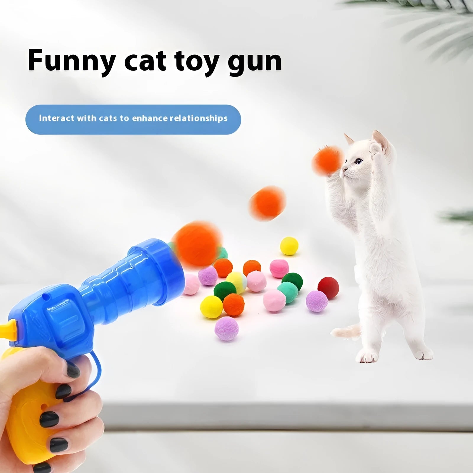 Plush ball launcher dog toy with soft pom-pom balls for indoor fetch games