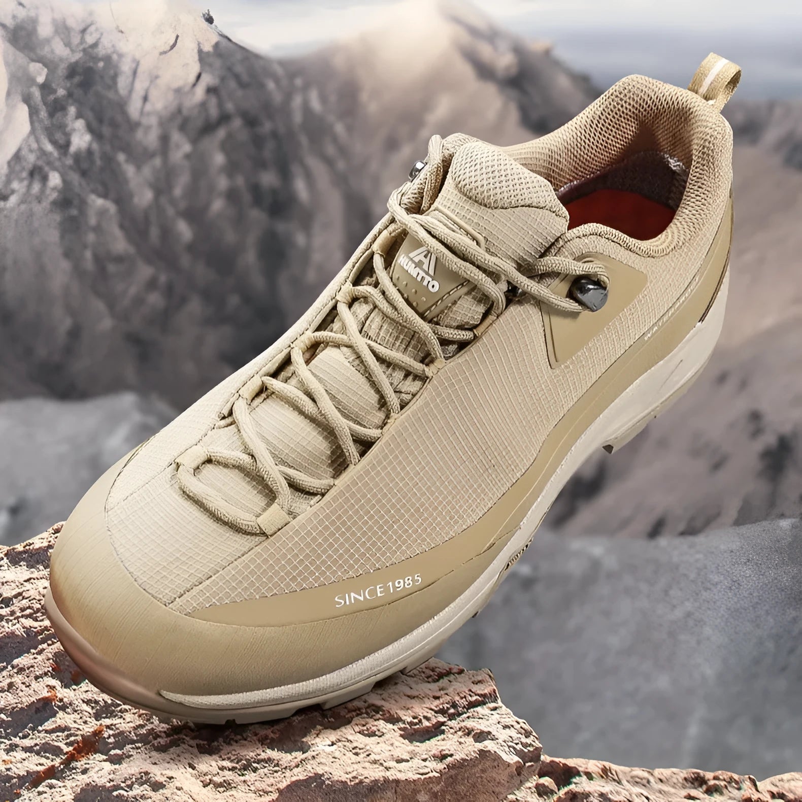 Men's low-top hiking boot in black with front lace-up, rubber outsole, and leather mesh upper.