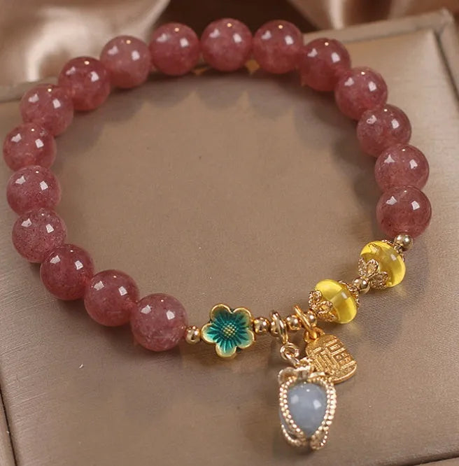 Red women's beaded bracelet with natural strawberry quartz stones and sparkling rhinestone accents.