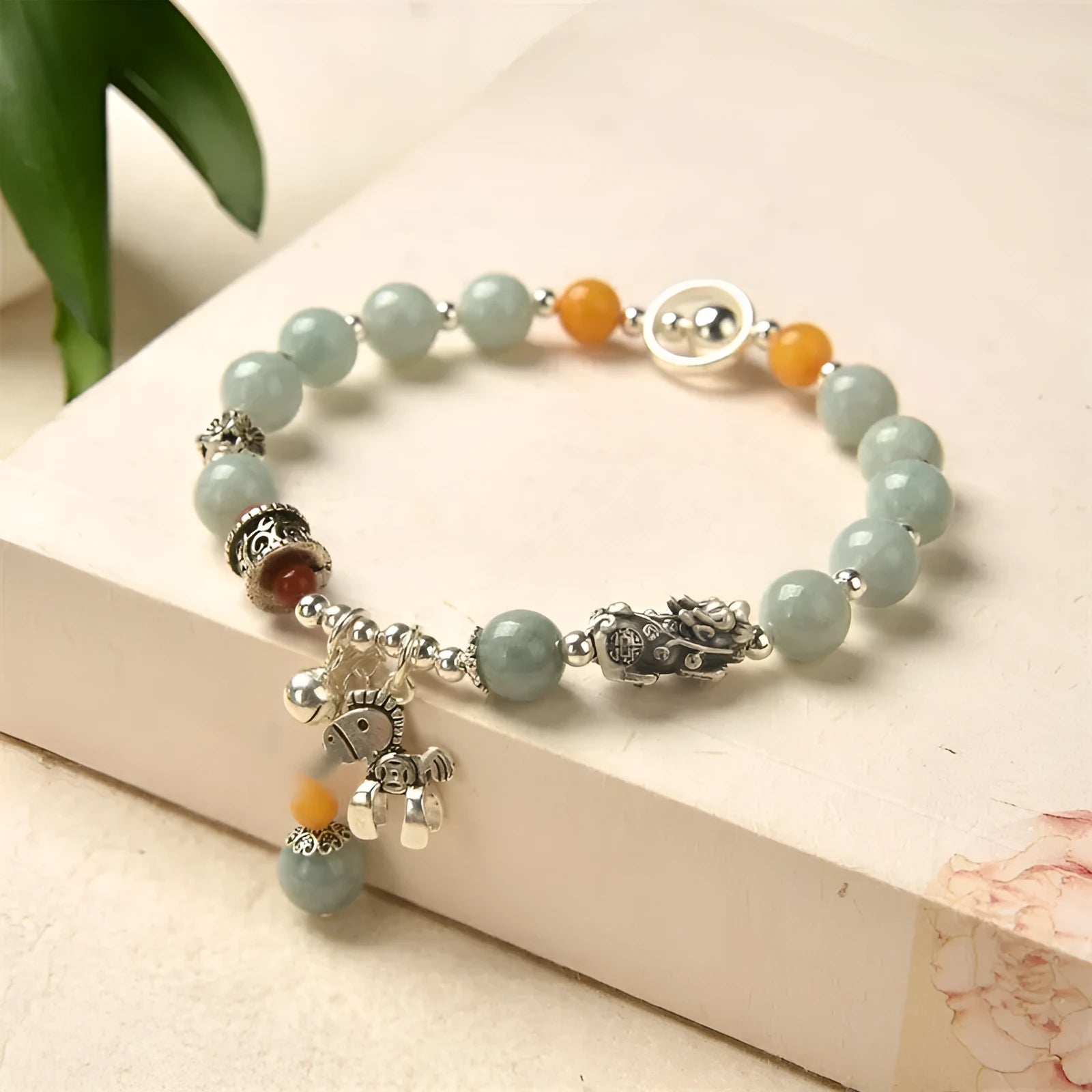 A vintage-style natural jade and alloy metal bracelet bangle for adults, showing retro pony style design.