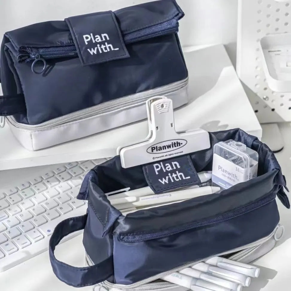 Dark blue folding double layer student pencil case made from polyester with internal compartments.