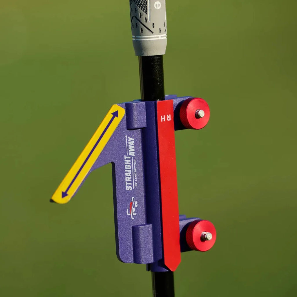 Plastic golf swing plane simulator training aid on practice surface