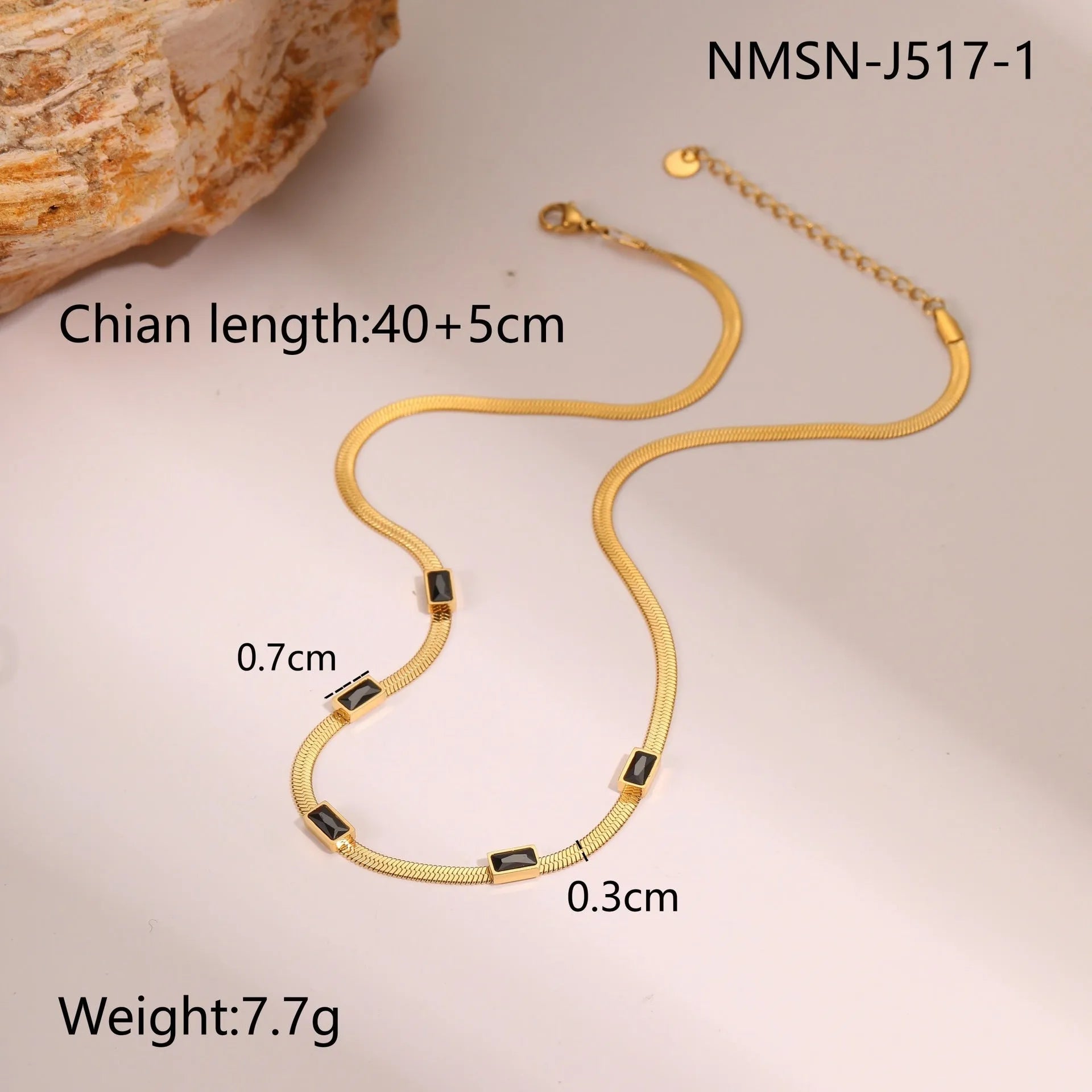 Gold geometric square zircon pendant necklace on a flat stainless steel snake chain.