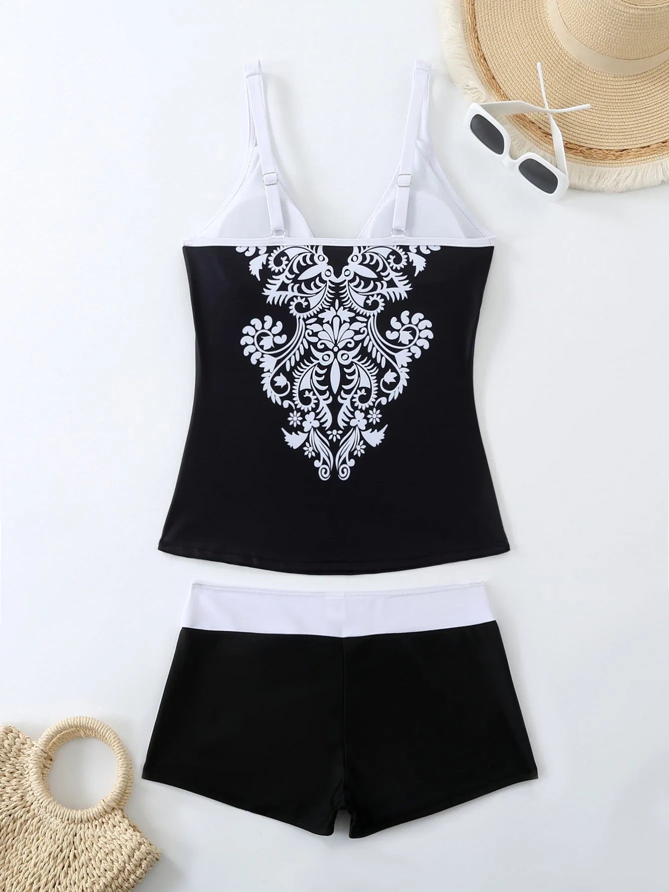 Plus size black printed swimsuit briefs for women on a hanger.