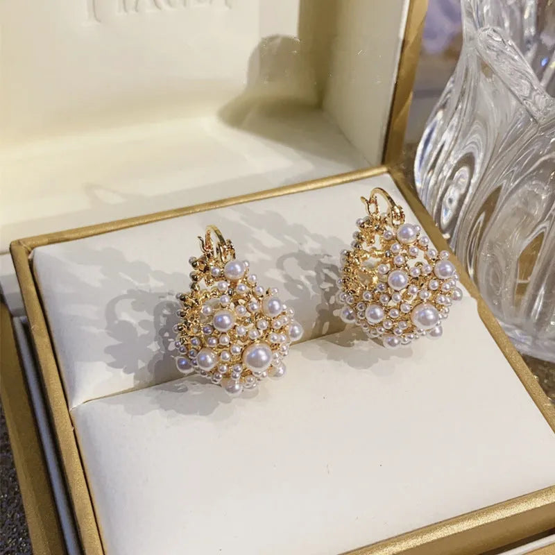 Women's gold-coloured copper flower basket earrings with small bead detailing and pearl inlay treatment