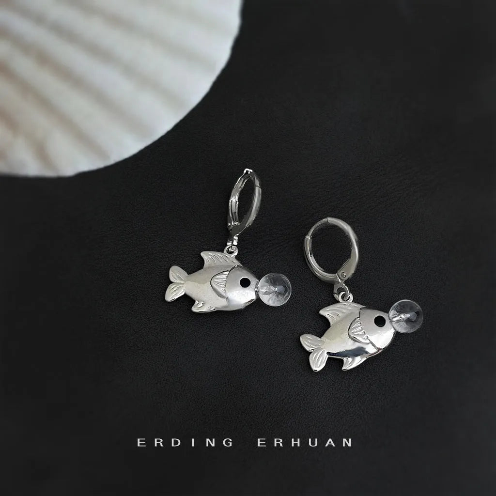 A pair of copper fish earrings with an electroplated goldfish bubble design.