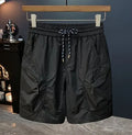 Man wearing loose fit camouflage cargo shorts made from quick-drying cotton blend fabric.