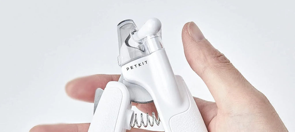 White pet nail clippers with LED light, transparent anti-splash baffle, and a nail file.