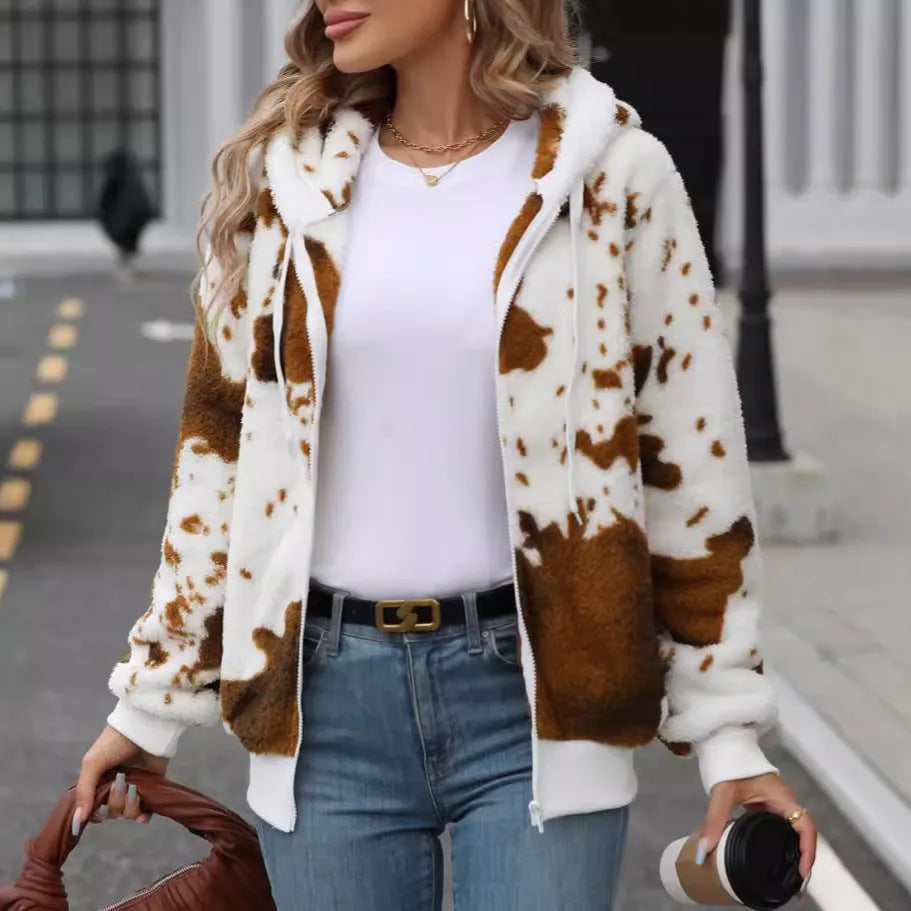 Yellow brown cow print hooded cardigan jacket with front zipper on a model.