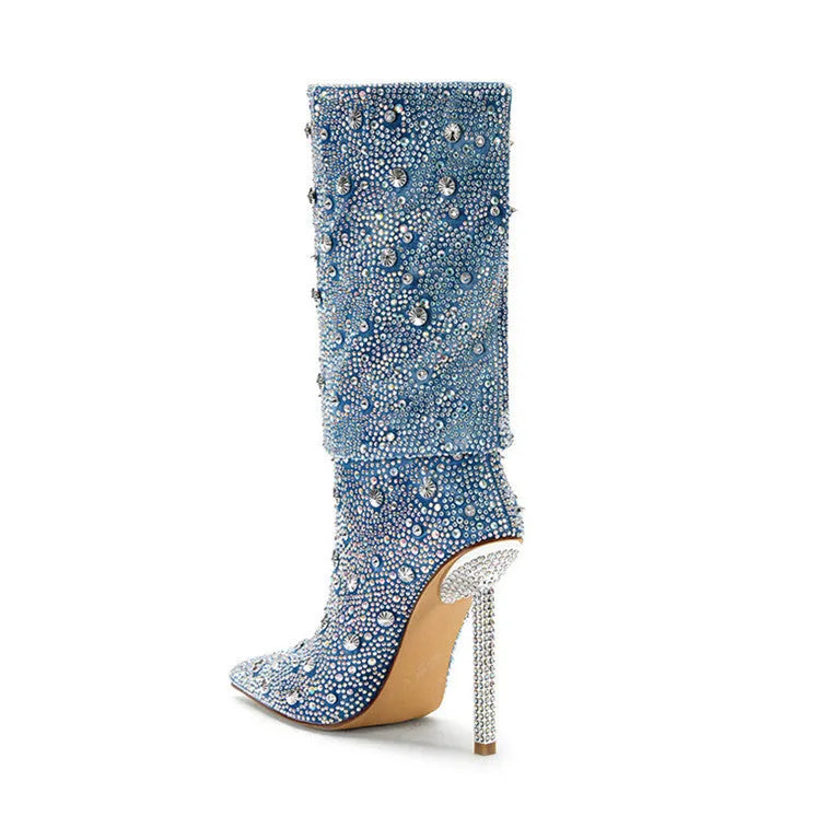 Women's blue denim pointed toe heel boots with stretchy fit on a plain background