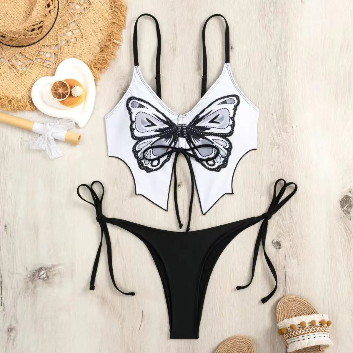Women's purple bow style split bikini swimsuit with sleeveless top and briefs.