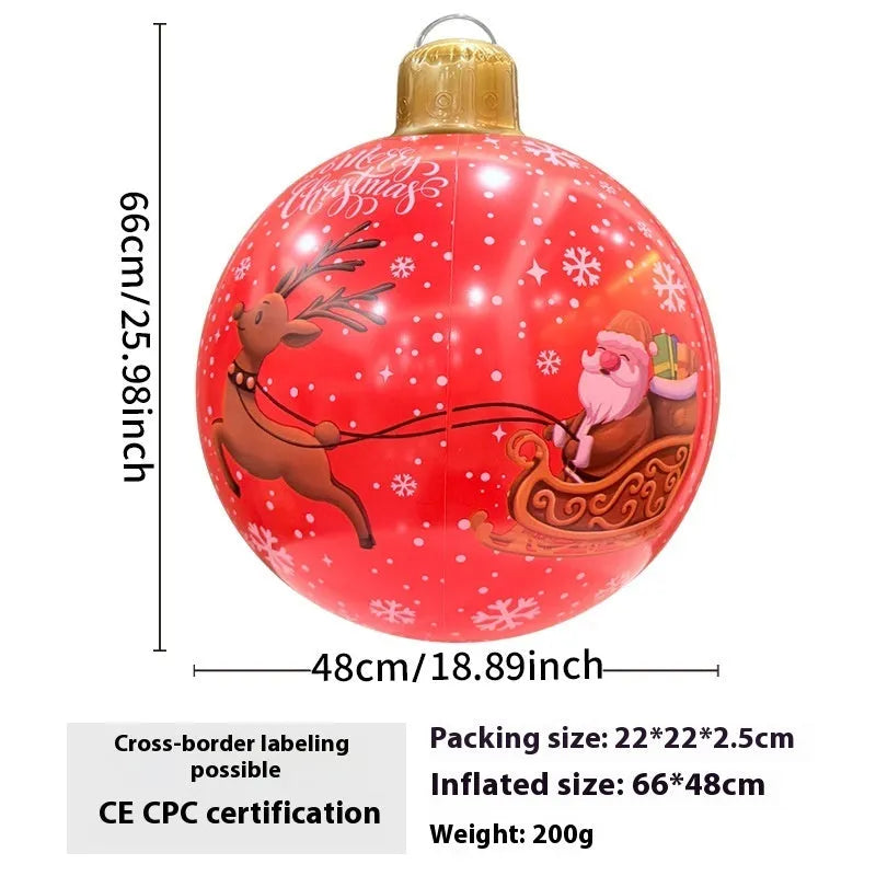 Large red inflatable Christmas ball with snowflake design and LED lights in outdoor garden setting