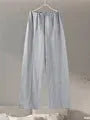 Women's apricot polar fleece suit set with long sleeve top and wide leg trousers on a hanger.