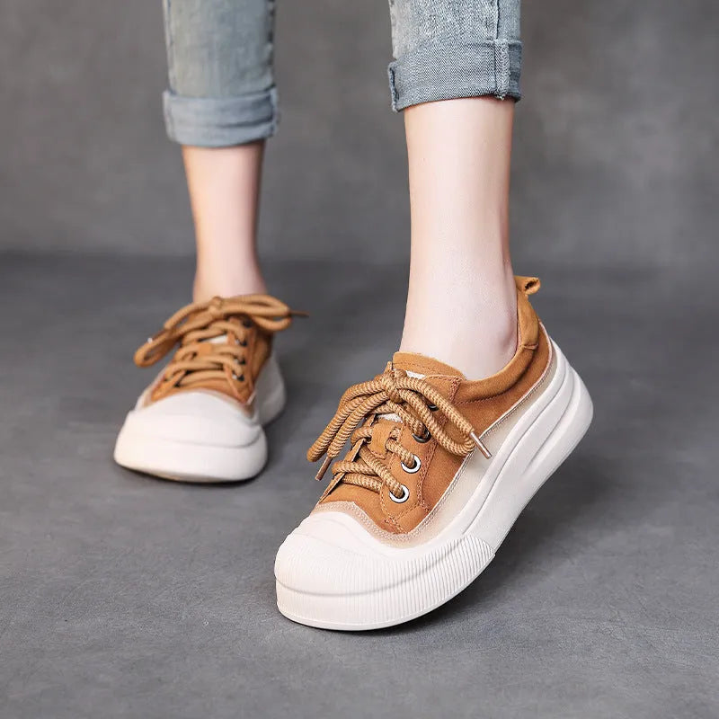 Women's yellow lace-up casual leather shoes with round toe and rubber sole on a neutral background.