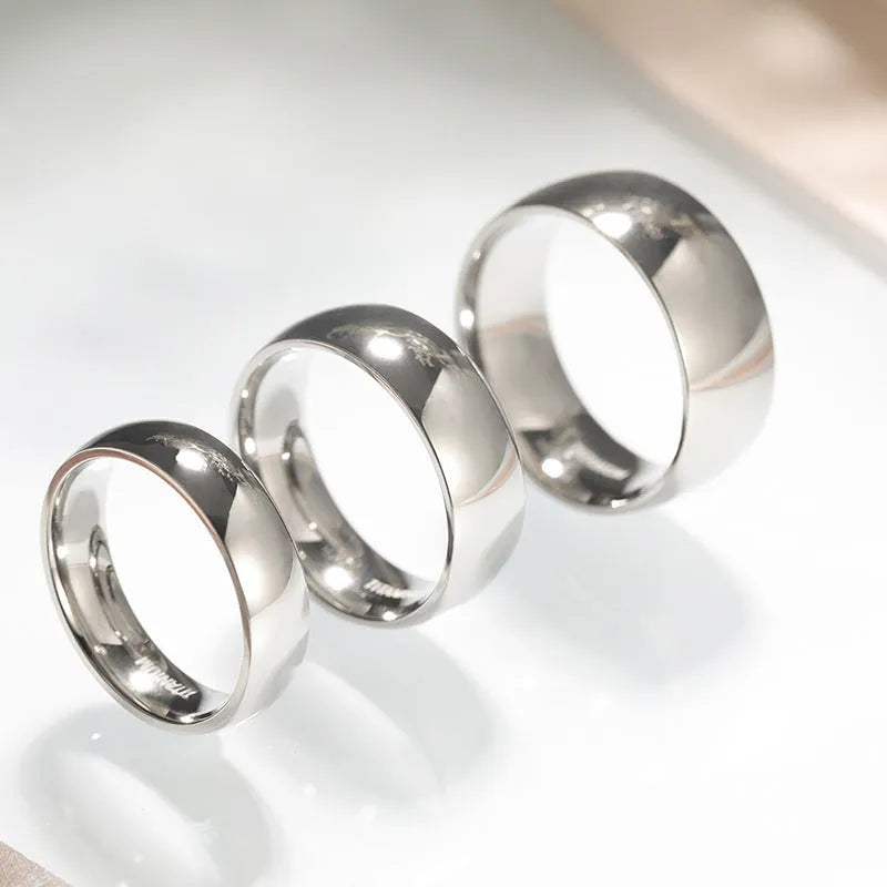 Matte silver titanium ring showing different band width options on a plain background