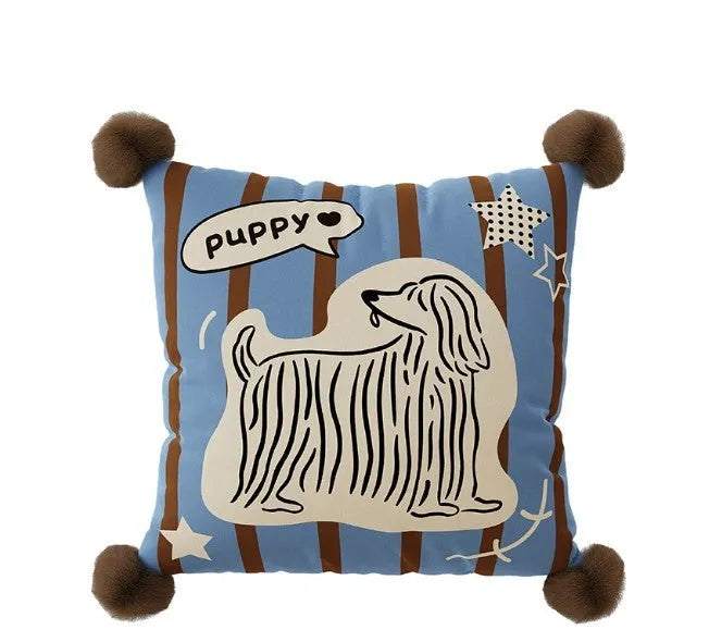 Blue cartoon animal printed cushion on a grey sofa showing removable cover.