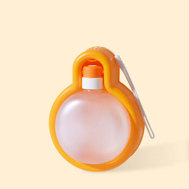 Green portable pet travel cup with extended drinking bowl and water bottle handle.