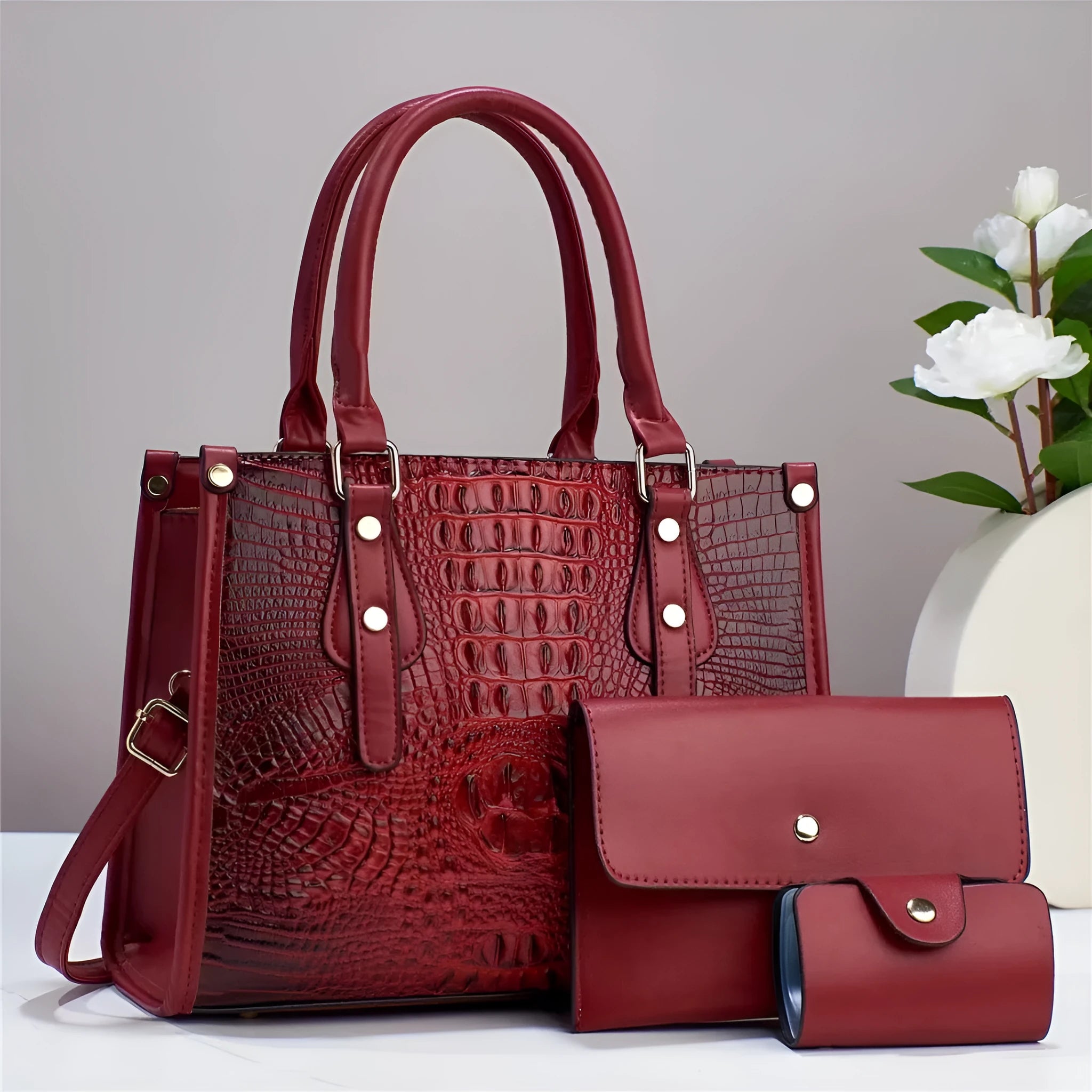 Contrast colour three-piece PU bag set showing crossbody bag, wallet, and card holder in burgundy.