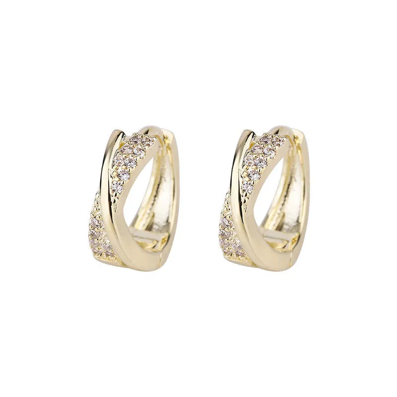 A pair of geometric drop earrings in 14K yellow, made from copper with zircon accents.