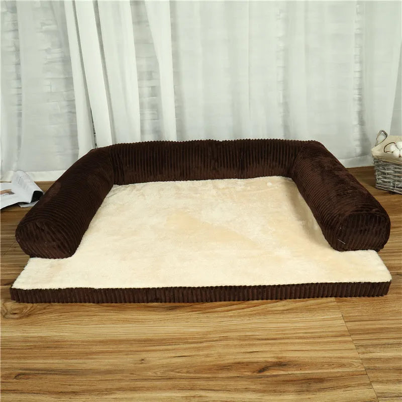 Grey corduroy dog sofa bed with raised sides on a wooden floor, showing its non-slip base.