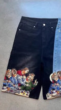 Blue men's cotton shorts with a Jesus design printed on the back pocket, showing tapered leg fit.
