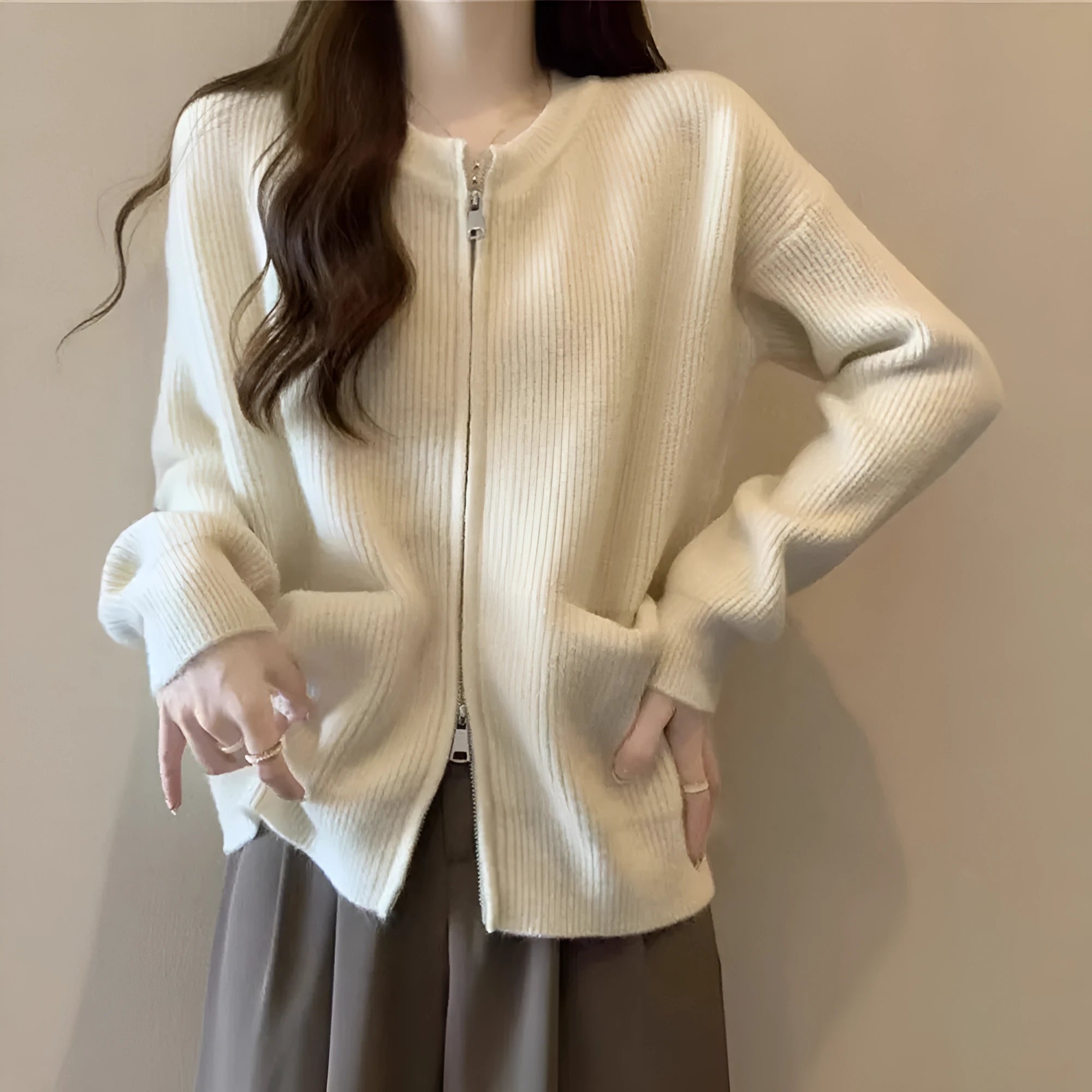 Beige viscose fibre soft wind cardigan coat with long sleeves on a hanger.