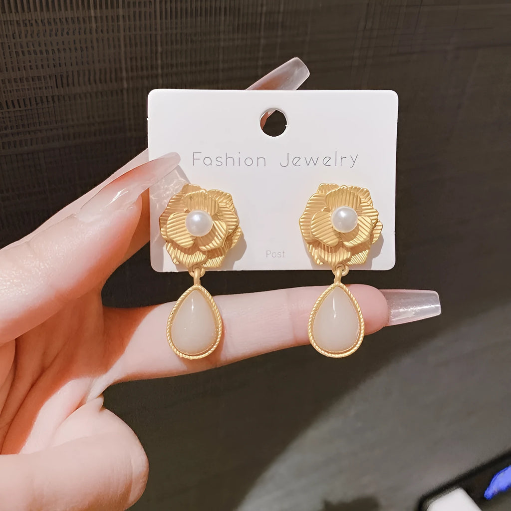 Gold electroplated sterling silver stud earrings with needle rose pearl design and opal stone accents