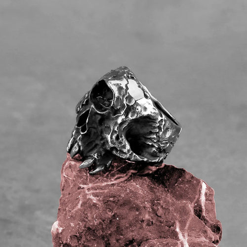 Alloy skull ring with one-eyed design in electroplated finish shown on finger