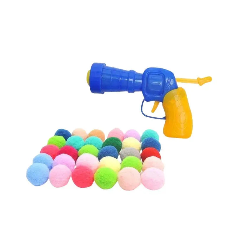 Plush ball launcher dog toy with soft pom-pom balls for indoor fetch games