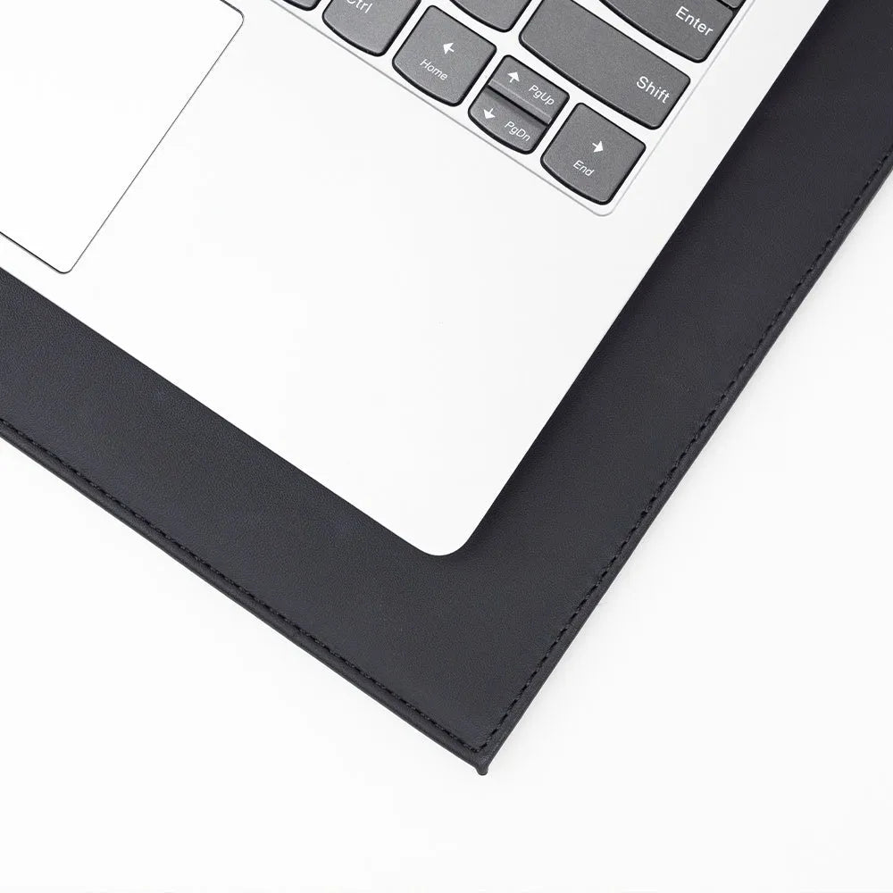 Heat-insulating laptop pad in black, gold, blue, and green colours on a desk