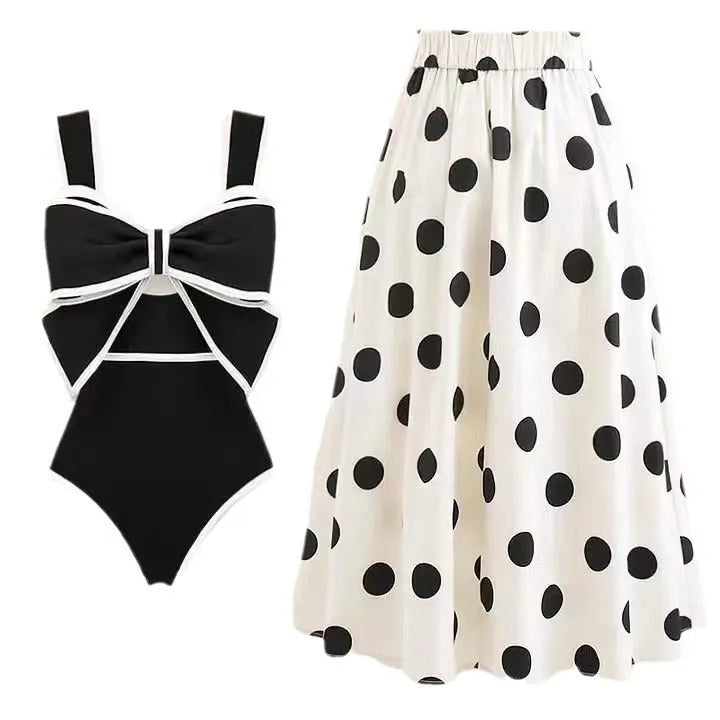 Women's black one-piece swimsuit with white round skirt and bow detail for beach and swimming