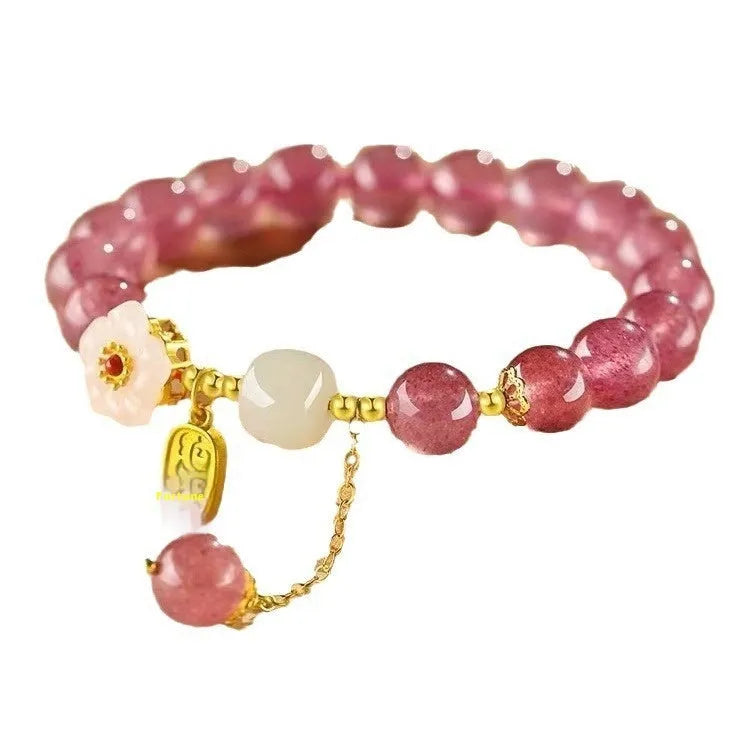 Handcrafted strawberry quartz crystal bracelet with green moon beads and peach blossom Hetian jade charm on adjustable string