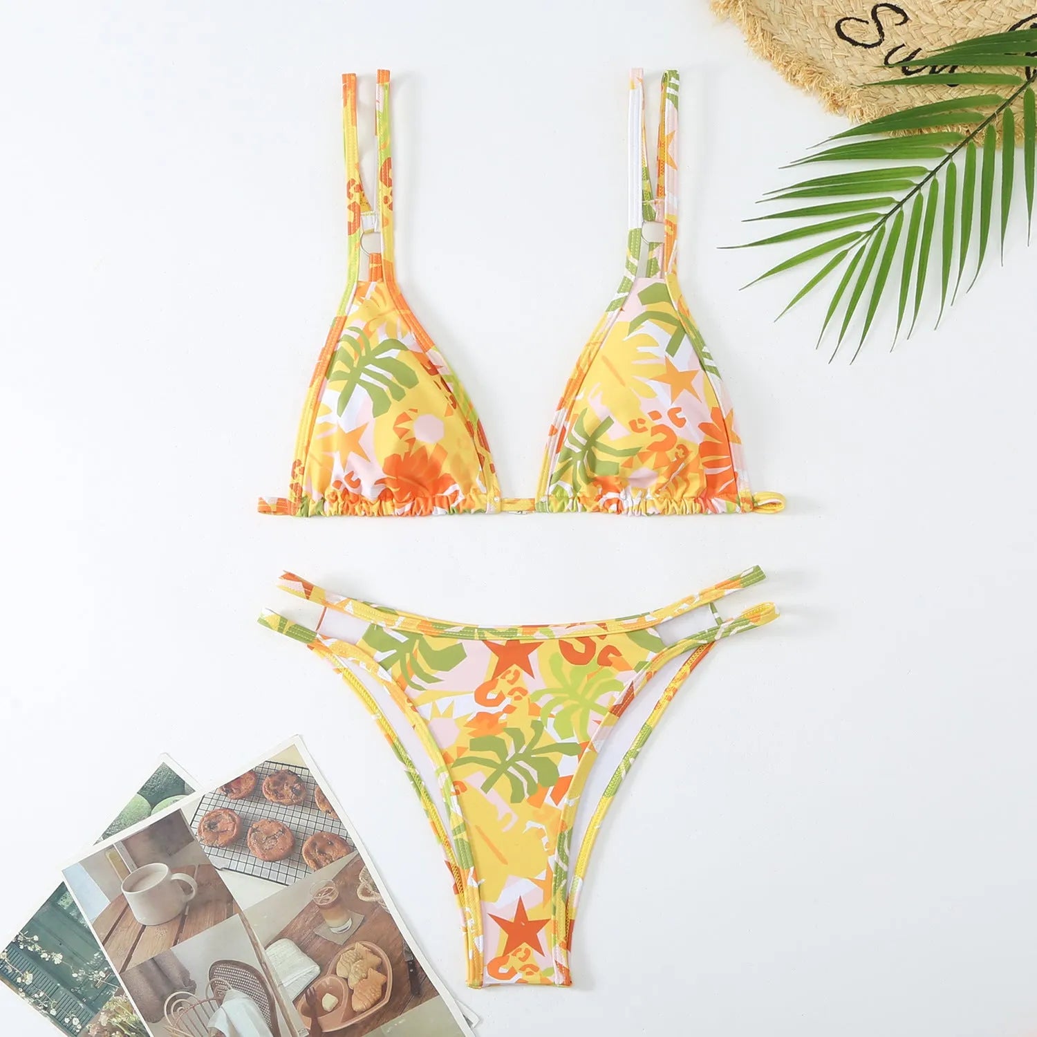 Women's printed halterneck bikini set in blue with floral pattern, showing top and briefs.