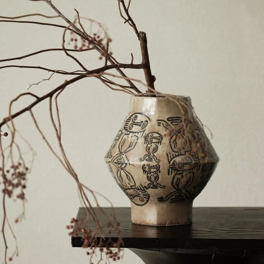 Hand-painted ceramic vase with vintage carved religious patterns in tribal totem colours
