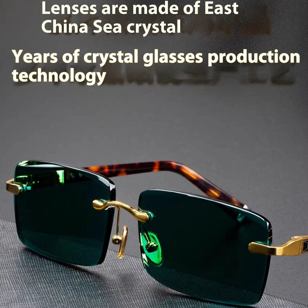 Dark green frameless crystal sunglasses with case and cleaning cloth on a solid background.