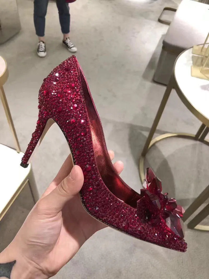 Women's gold pointed toe high heels with rhinestone detail and stiletto heel