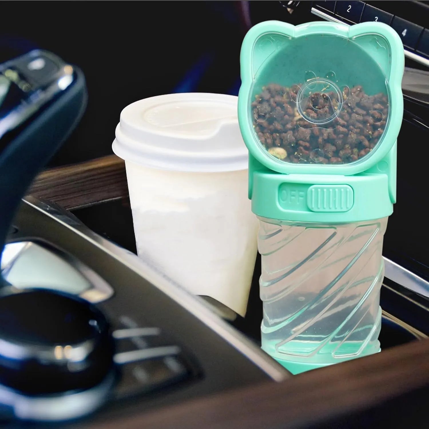 Green 3-in-1 portable pet water bottle with food container and waste bag dispenser attached to a strap.
