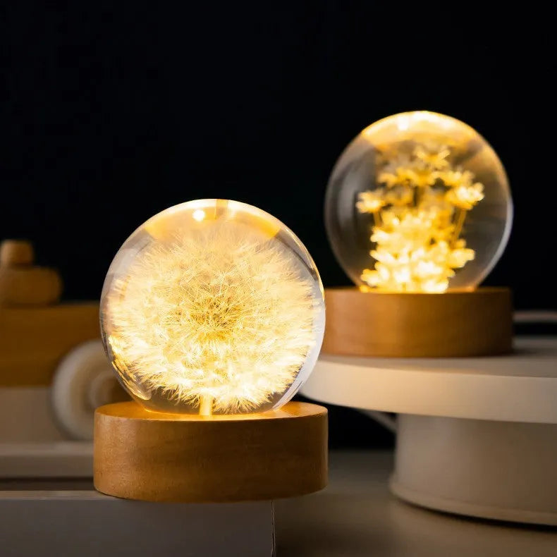 Dandelion eternal flower inside a clear resin crystal ball USB night light on a beech wood stand.