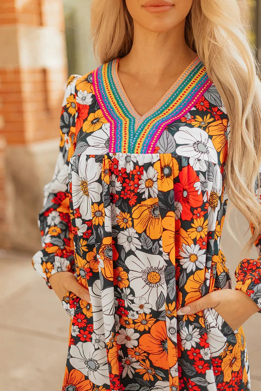 Orange floral print mini dress with lace-trimmed V-neck and long sleeves.