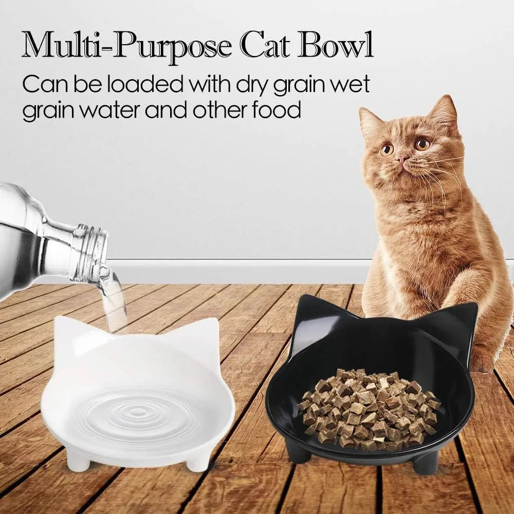 Set of four shallow black and white cat bowls with non-slip bases on a kitchen counter